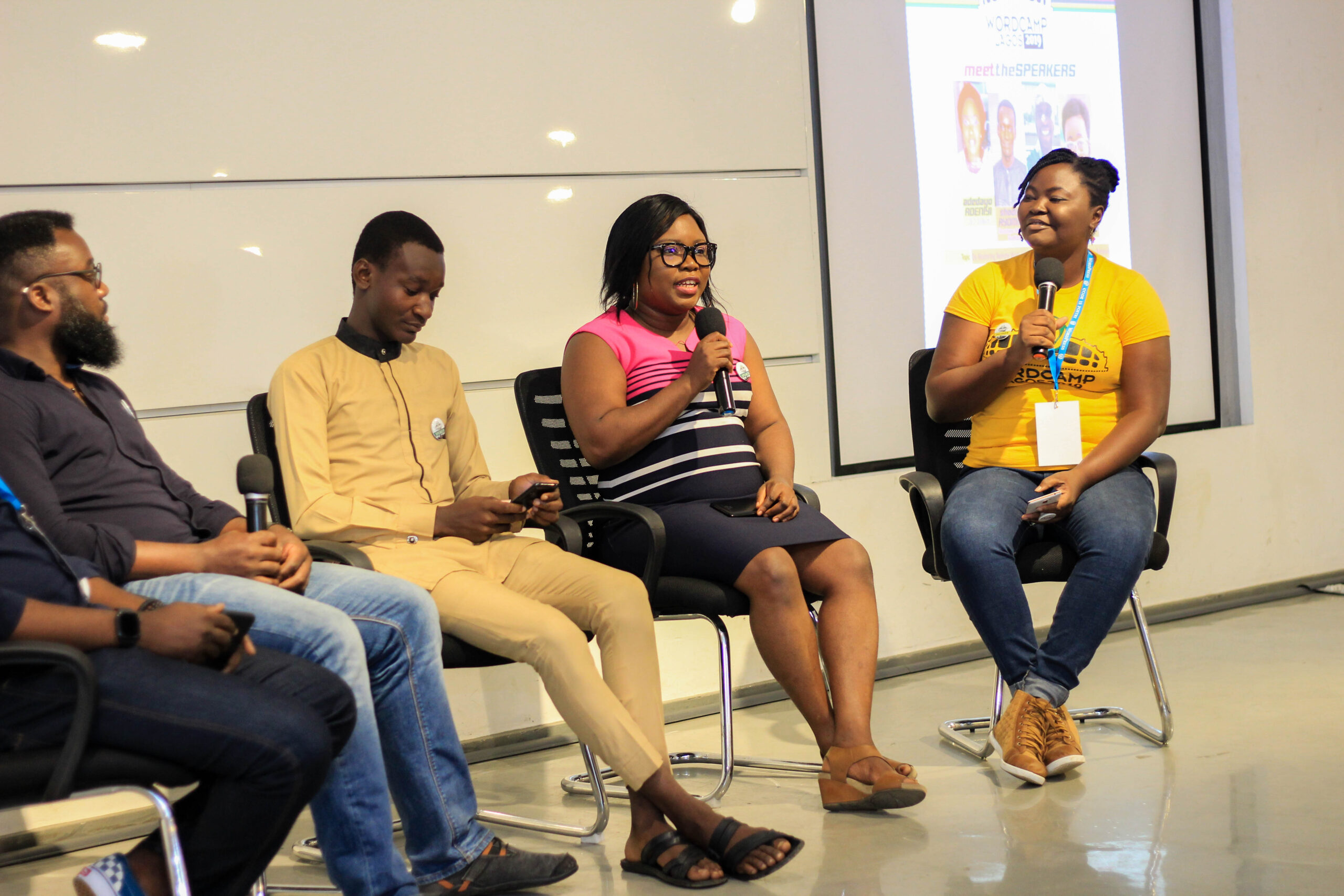 Me, reflecting on personal growth while looking at this photo of me moderating a panel at wordcamp lagos in 2019